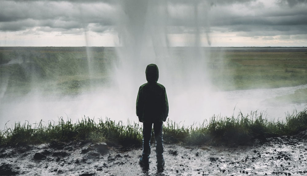 Standing under waterfall